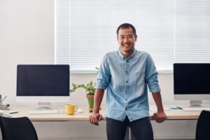 a smiling creative in his office