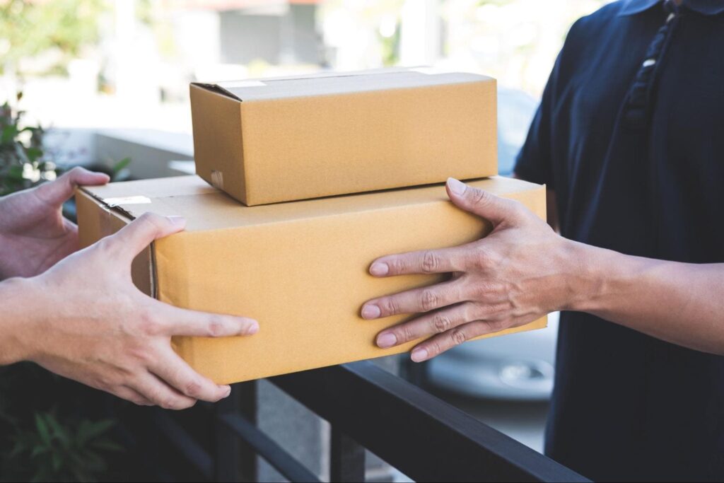 Delivery man handing off shipment to the customer.